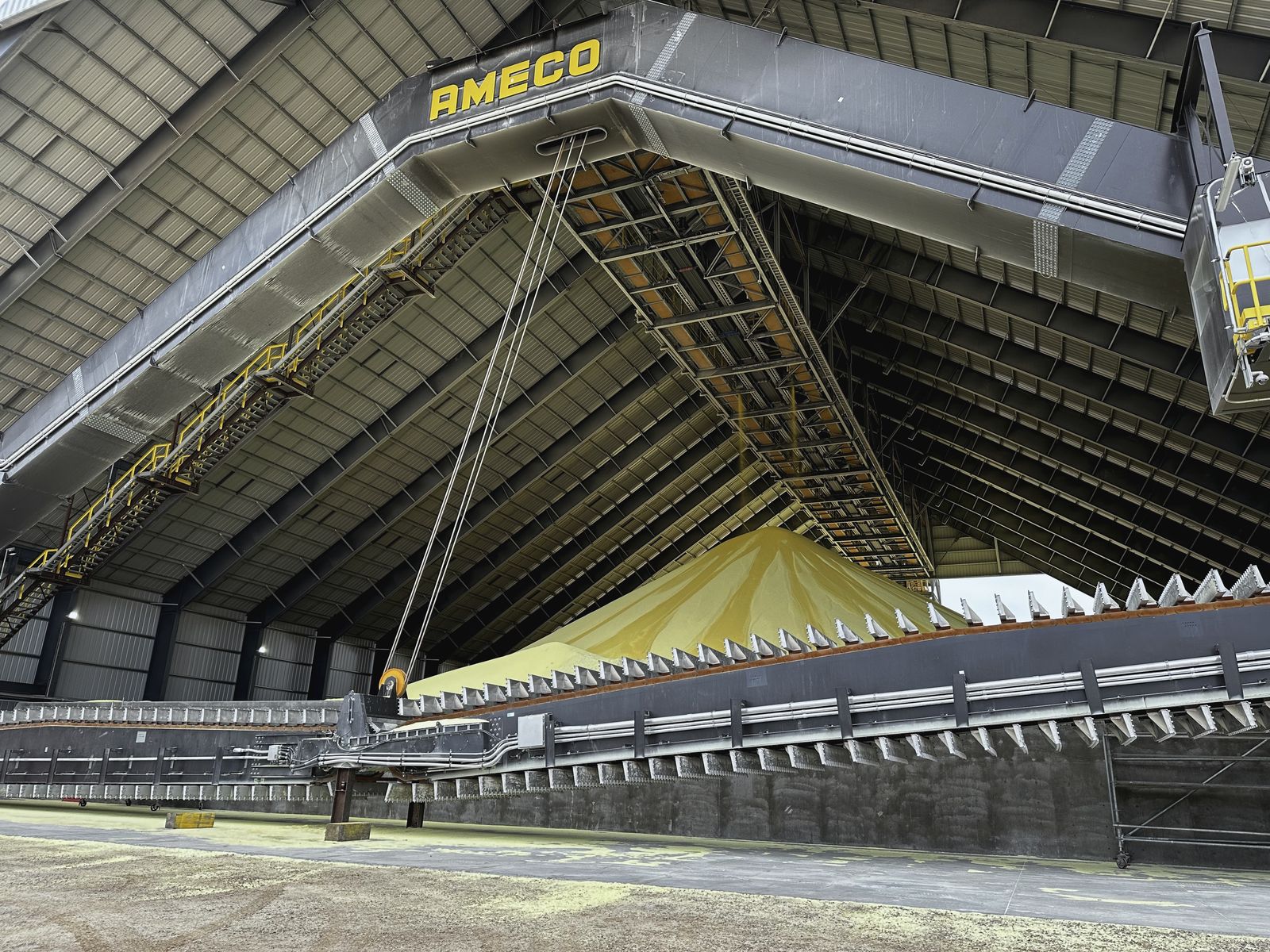 Interior of a bulk sulphur storage building showing the stockpile and roof structure