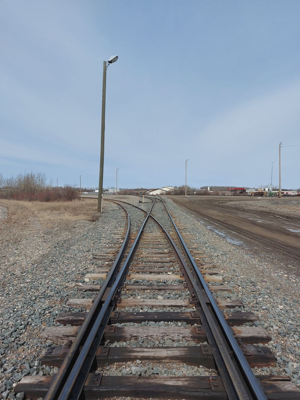 Mainline track running toward the horizon through open prairie